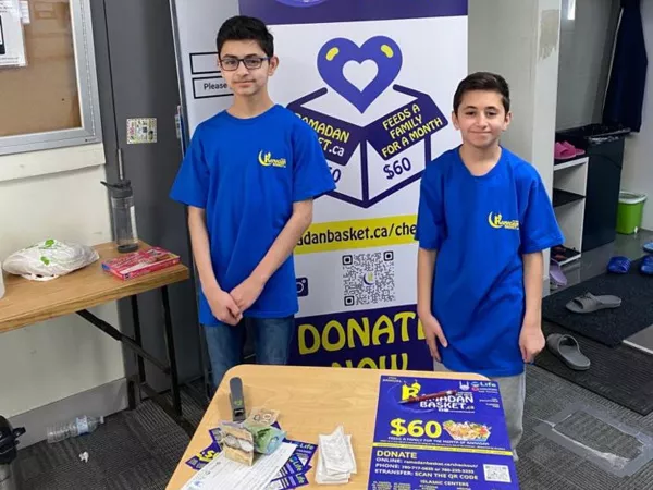 Volunteers packing baskets with essentials